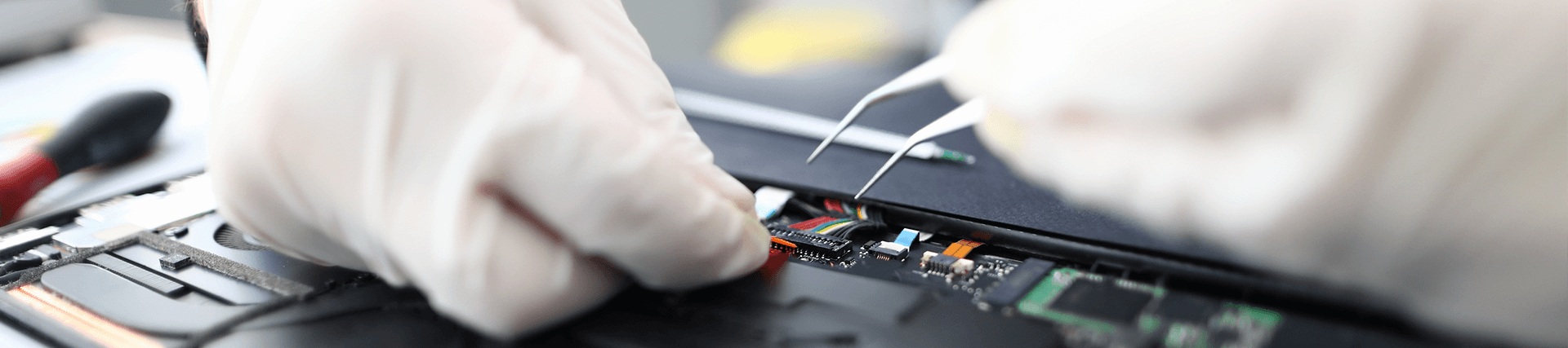 technician working on biomedical equipment with tools