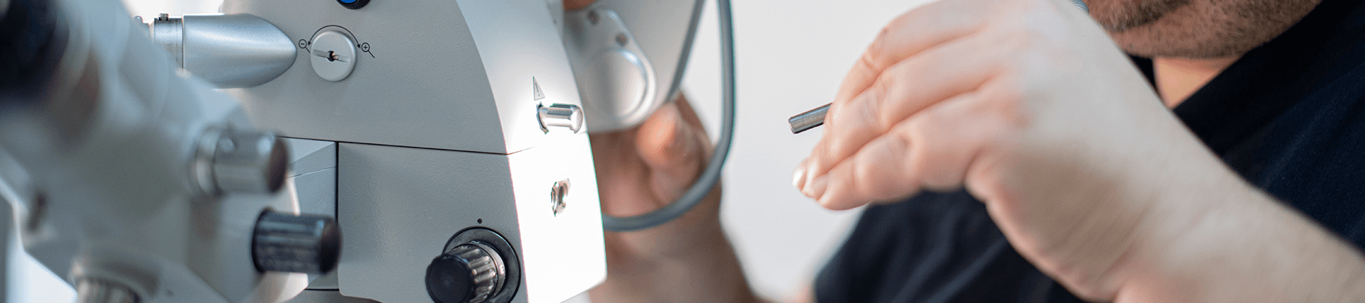 technician working on biomedical equipment with tools