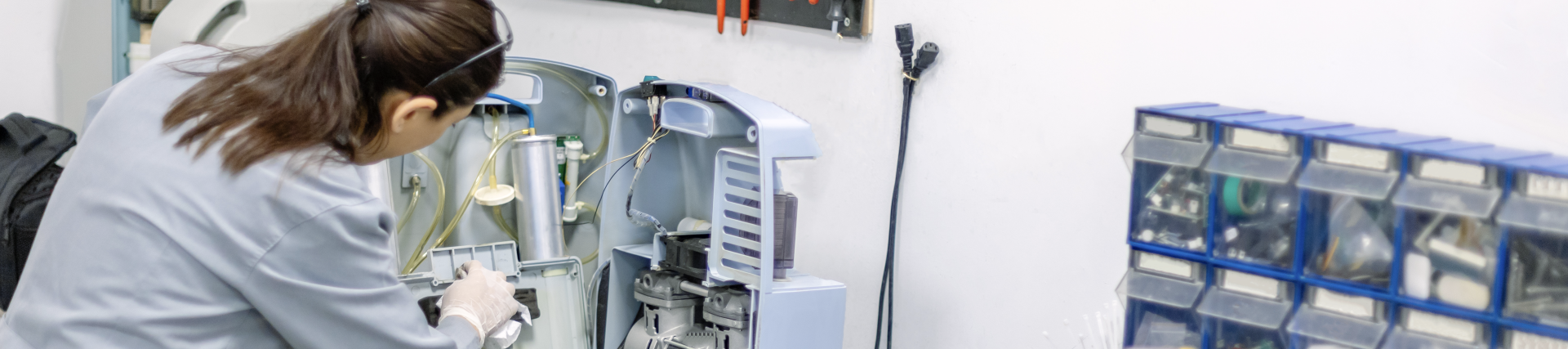 technician working on oxygen concentrator with tools